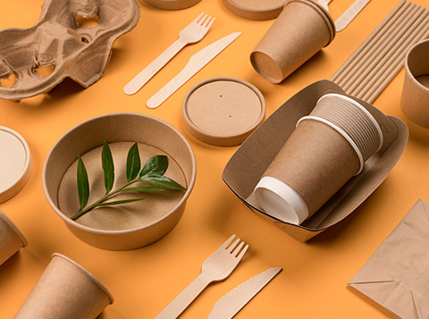 different types of food packaging laid out on an orange background