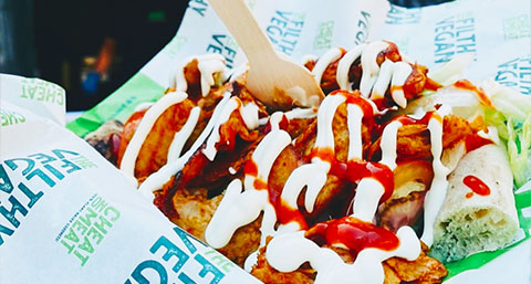 takeaway vegan food served on top of branded grease proof paper