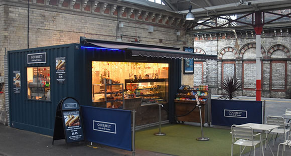 an outdoor food stall at a train station 